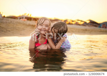 Enjoying joyful moments with family at the beach during sunset Enjoying joyful moments with family at the beach during sunset 128006674