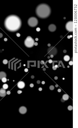 Black background with floating glowing bokeh particles in soft focus and grayscale tones 128006732