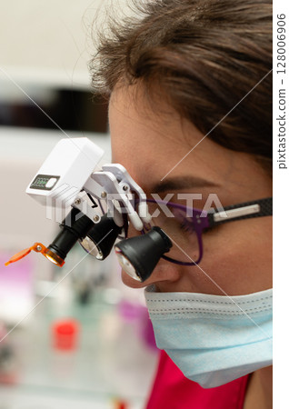 Focused examination in a modern laboratory setting showcasing advanced magnification tools, highlighting precision work during daylight hours Focused examination in a modern laboratory setting showcasing advanced magnification tools, highlighting precision work during daylight hours 128006906