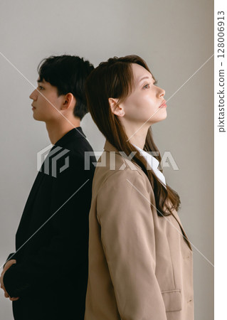Back to back man and woman 128006913