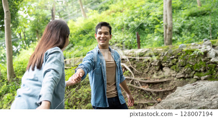 Couple Holding Hands in Nature. Connection and joy in the outdoors. Couple Holding Hands in Nature. Connection and joy in the outdoors. 128007194