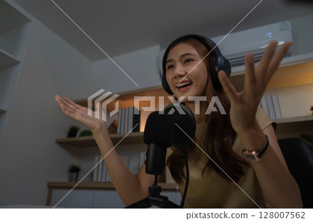Digital Communication and Remote Work. Young woman animatedly participating in online meeting. 128007562