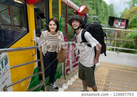 Inbound couple riding a cable car 128007703