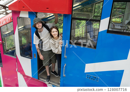 Inbound couple riding a cable car 128007716