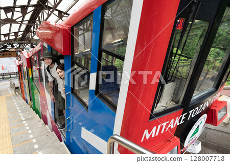 Inbound couple riding a cable car 128007718