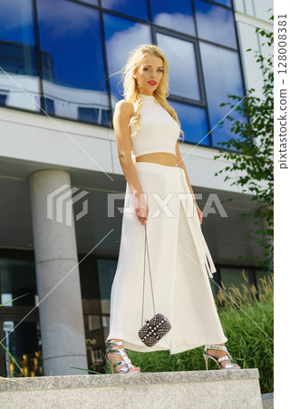 Woman wearing crop top and culottes Woman wearing crop top and culottes 128008381