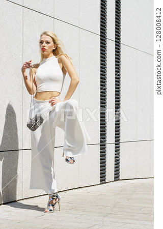 Woman wearing crop top and culottes Woman wearing crop top and culottes 128008412