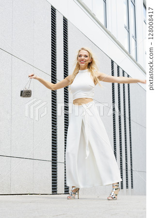 Playful woman wearing crop top and culottes Playful woman wearing crop top and culottes 128008417