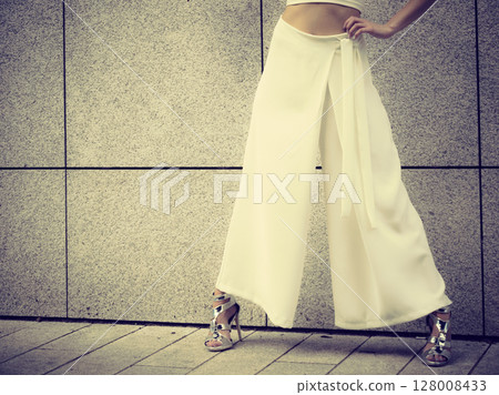 Woman wearing high heels and culottes Woman wearing high heels and culottes 128008433