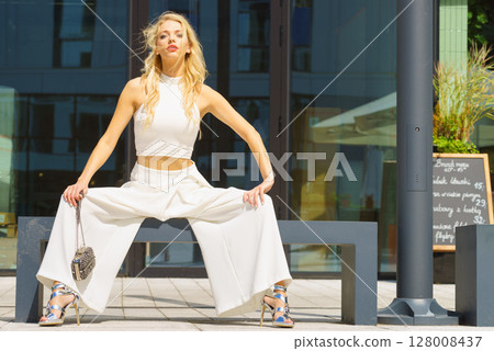 Woman wearing crop top and culottes Woman wearing crop top and culottes 128008437