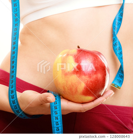 Diet. Fit girl with measure tape and apple fruit Diet. Fit girl with measure tape and apple fruit 128008643