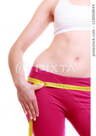 Fitness woman fit girl with measure tape measuring her loins 128008644