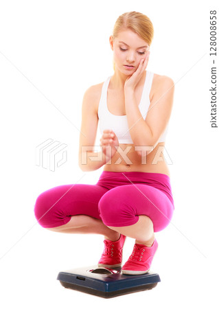 Upset woman weighing scale. Slimming weight loss. 128008658