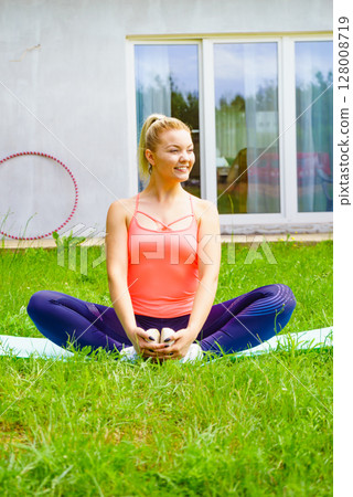 Woman doing exercises gym in garden at home 128008719