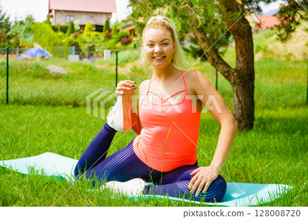 Woman doing exercises gym in garden at home 128008720