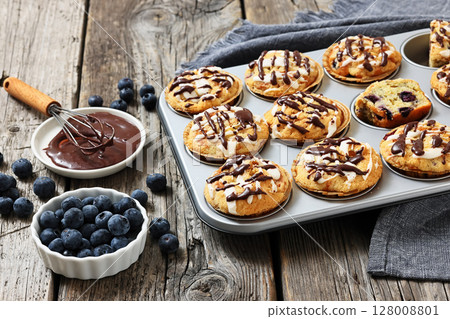 tasty blueberry muffins with lemon chocolate glaze tasty blueberry muffins with lemon chocolate glaze 128008801