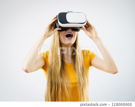 Girl wearing virtual reality goggles. Girl wearing virtual reality goggles. 128008808
