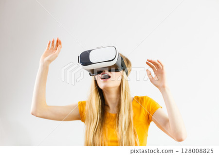 Girl wearing virtual reality goggles. Girl wearing virtual reality goggles. 128008825
