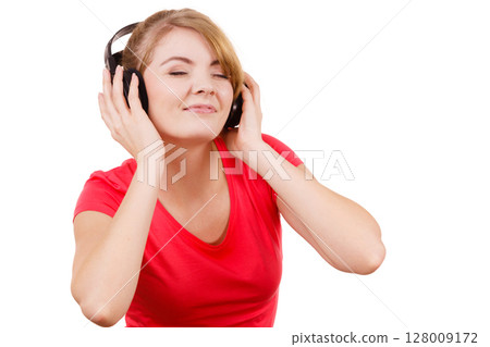 Woman in big headphones listening music isolated Woman in big headphones listening music isolated 128009172