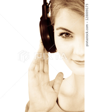 Woman in big headphones listening music isolated Woman in big headphones listening music isolated 128009173