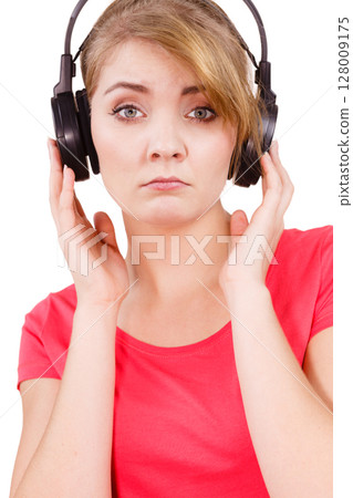 Woman sad girl in big headphones listening music Woman sad girl in big headphones listening music 128009175