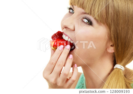 Woman eating cupcake sweet food 128009193