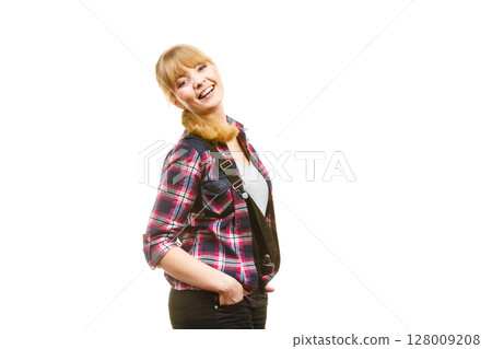 Standing woman wearing dungarees laughing 128009208