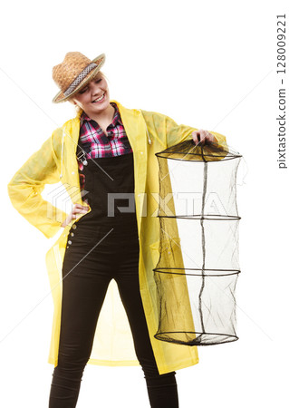 Happy woman holding empty fishing keepnet 128009221