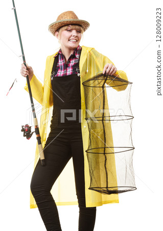 Happy woman holding fishing rod and keepnet Happy woman holding fishing rod and keepnet 128009223