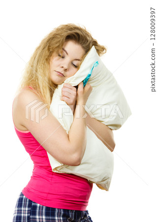 Sleepy woman hugging white pillow 128009397