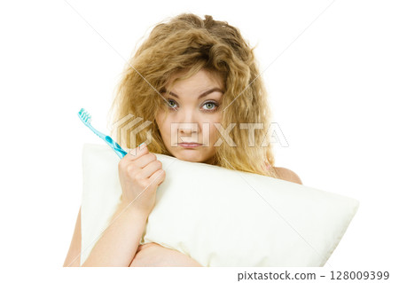 Sleepy woman hugging white pillow 128009399