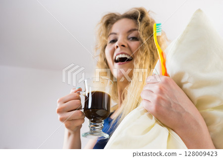 Funny woman being late drinking coffee Funny woman being late drinking coffee 128009423