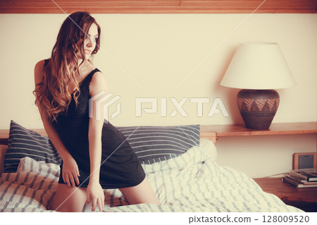 Seductive young woman in lingerie in bed. 128009520