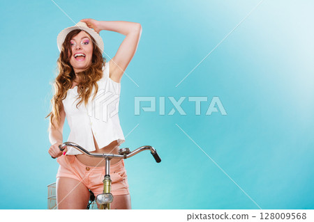 Active woman riding bike bicycle. Recreation. 128009568