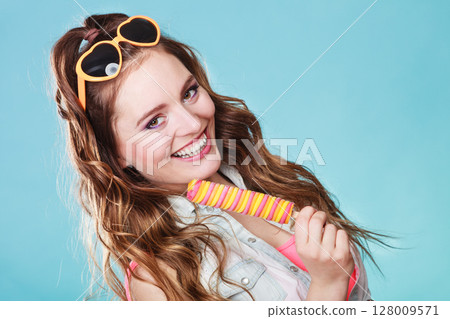 Summer woman eating popsicle ice pop cream Summer woman eating popsicle ice pop cream 128009571