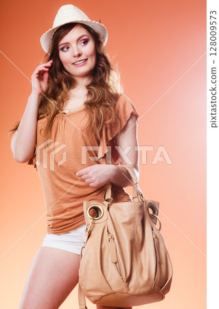 Lovely woman in summer hat handbag portrait Lovely woman in summer hat handbag portrait 128009573