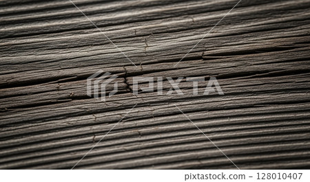 Macro close up of rustic weathered wooden surface with deep cracks and rough texture 128010407