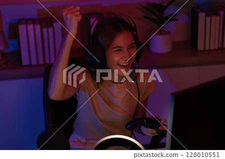 Gamer in Thrilling Moment of Gameplay with Controller 128010551