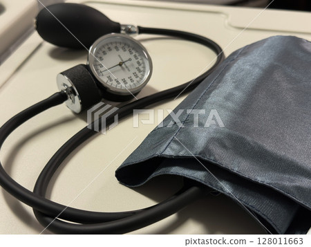 Manual Blood Pressure Cuff on Hospital Table Manual Blood Pressure Cuff on Hospital Table 128011663