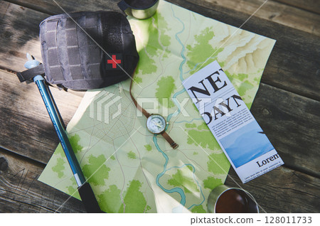 Flat Lay of Hiking Essentials Including Map, Compass, and First Aid Kit on Wooden Surface Flat Lay of Hiking Essentials Including Map, Compass, and First Aid Kit on Wooden Surface 128011733