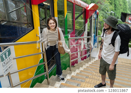 Inbound couple riding a cable car 128011867