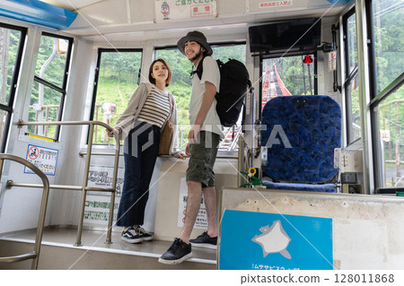 Inbound couple riding a cable car 128011868