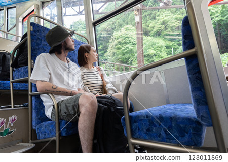 Inbound couple riding a cable car 128011869