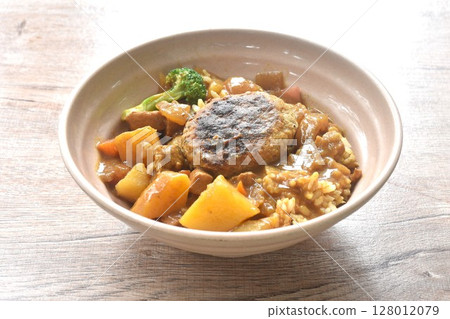 hamburg crispy fried chop pork with boiled vegetable topping plain rice dressing potato and carrot in Japanese curry on bowl 128012079