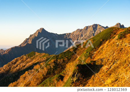 Early morning view of the Hotaka mountain range (Maehotakadake and Tsurione) from the Kisaku Shindo trail. Climbing Mt. Yari on the Northern Alps Omote Ginza traverse. 128012369
