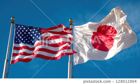 American and Japanese flags waving together against clear blue sky, symbolizing international friendship and cooperation 128012804