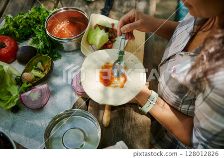 Preparing Fresh Tacos Outdoors with Vibrant Ingredients 128012826