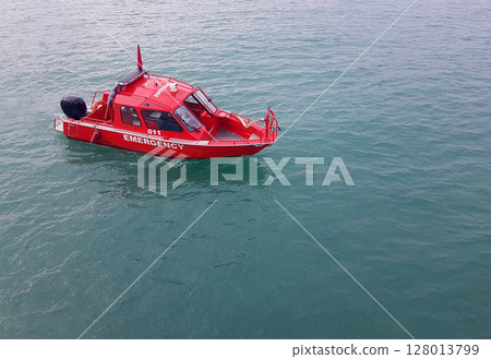 Red emergency boat through the sea, top view 128013799