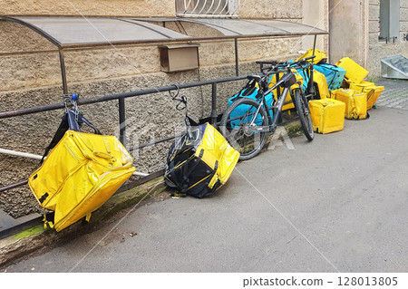 Yellow and blue delivery backpack on empty street 128013805
