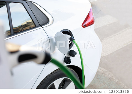 Electric car recharging in charging station Electric car recharging in charging station 128013826
